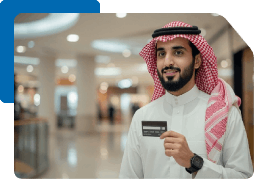 Smiling Saudi man in thobe proudly holds black credit card indoors.